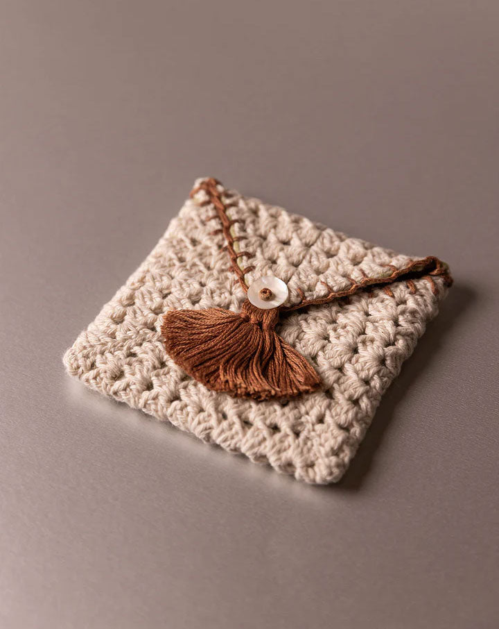 Handmade crochet pouch, eco-friendly and stylish accessory by The Mango House Trust