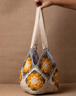 Daisy crochet bucket bag, handmade eco-friendly handbag by The Mango House Trust